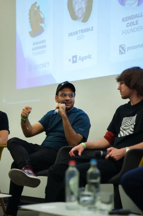 A panel of five speakers on stage in front of a screen reading 'Building Crosschain Infra in a Modular World'.