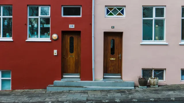 Two adjacent house front doors numbered 39 and 41, set in red and pink building facades.