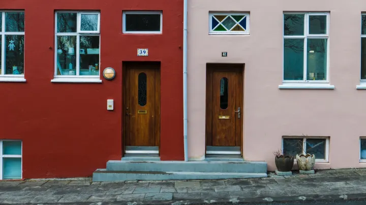 Two adjacent house front doors numbered 39 and 41, set in red and pink building facades.