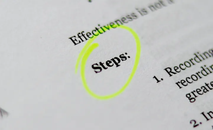 Close-up of a printed page with the word 'Steps:' circled in yellow highlighter.
