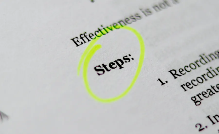 Close-up of a printed page with the word 'Steps:' circled in yellow highlighter.